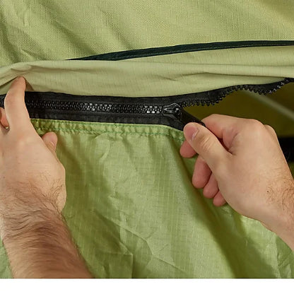 Hands zipping Yakima SkyRise HD Annex to rooftop tent during setup