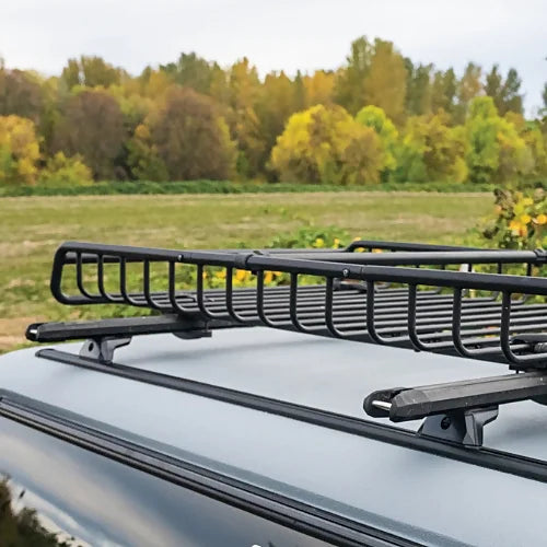 Yakima TrackTower roof rack towers supporting rooftop cargo basket on vehicle track system